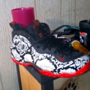 A pair of all most new nike foamposite blk wt red